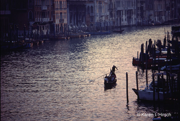 Gondolier on Grand Canal at sunset, Venice, Italy